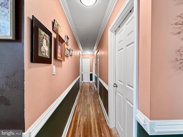 hall featuring dark wood-style flooring and ornamental molding