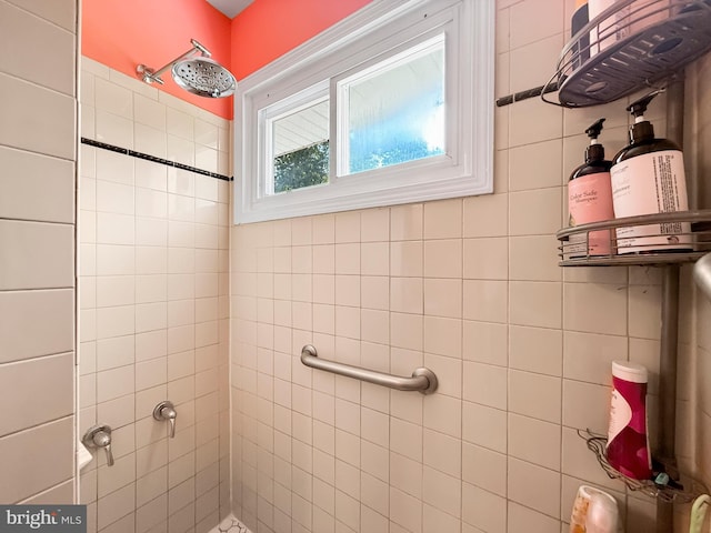 full bath featuring tiled shower
