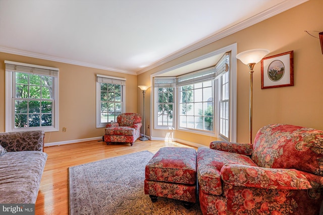living room with baseboards, ornamental molding, and wood finished floors
