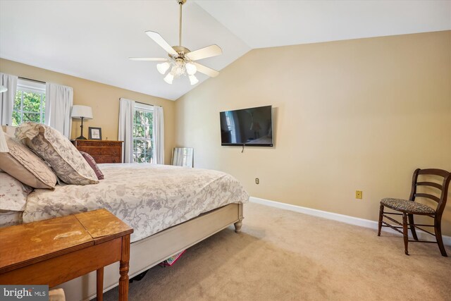bedroom featuring baseboards, a ceiling fan, light colored carpet, and lofted ceiling