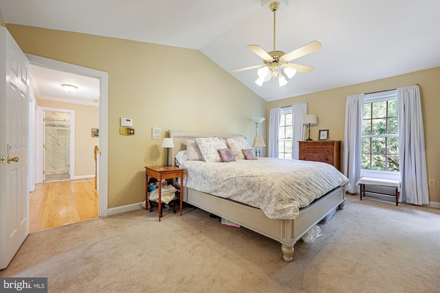bedroom featuring baseboards, vaulted ceiling, light carpet, and ceiling fan