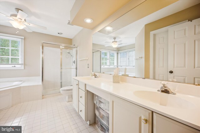 bathroom with ceiling fan, a healthy amount of sunlight, a sink, and tile patterned flooring
