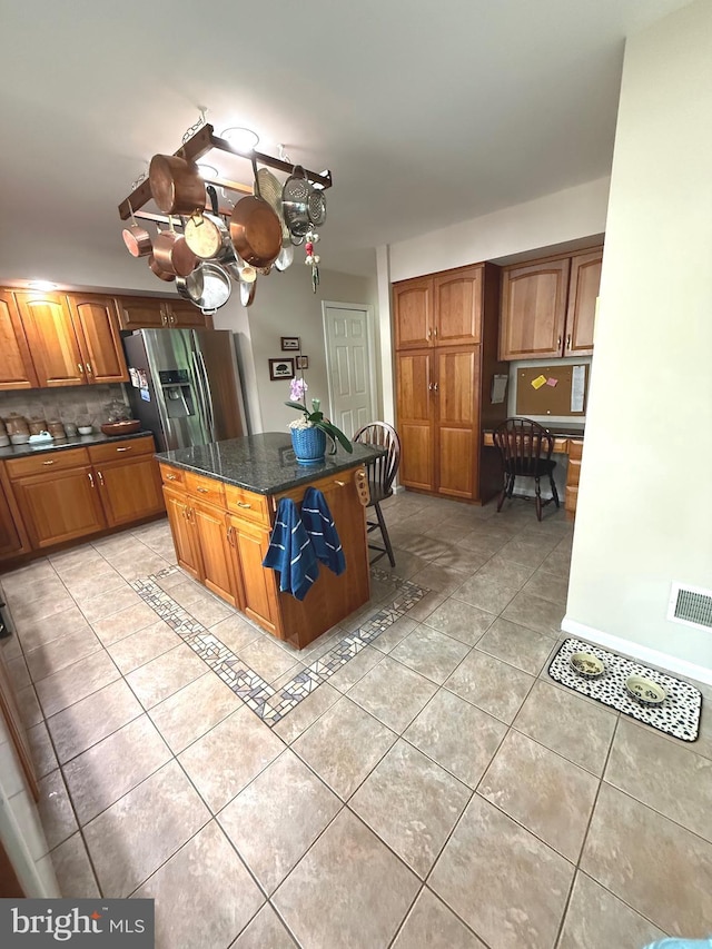 902 Hedgewyck Ln, Elizabethtown, PA 17022 - kitchen with light tile patterned flooring, stainless steel fridge with ice dispenser, brown cabinets, tasteful backsplash, and a kitchen island
