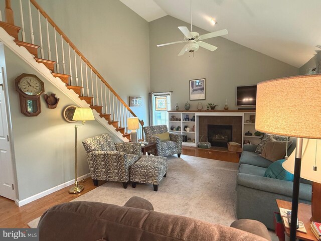 902 Hedgewyck Ln, Elizabethtown, PA 17022 - living room featuring high vaulted ceiling, stairs, wood finished floors, a tile fireplace, and a ceiling fan