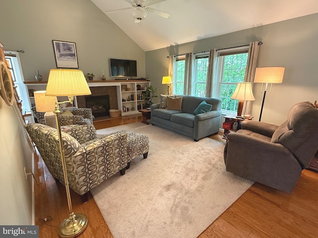 902 Hedgewyck Ln, Elizabethtown, PA 17022 - living area featuring a ceiling fan, wood finished floors, high vaulted ceiling, and a tile fireplace