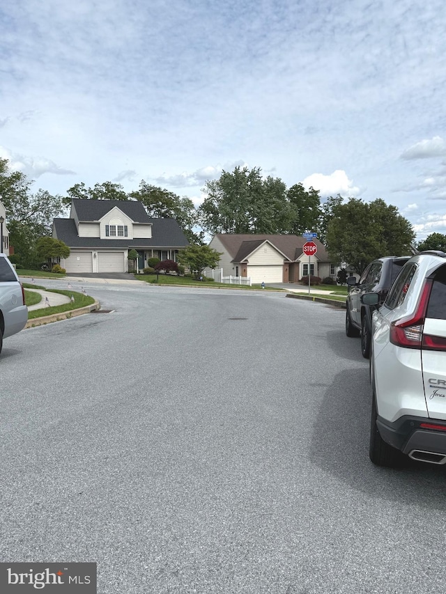 902 Hedgewyck Ln, Elizabethtown, PA 17022 - view of asphalt street featuring curbs, a residential view, traffic signs, and sidewalks