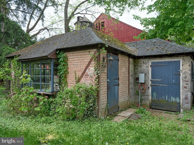 view of outbuilding with a sunroom