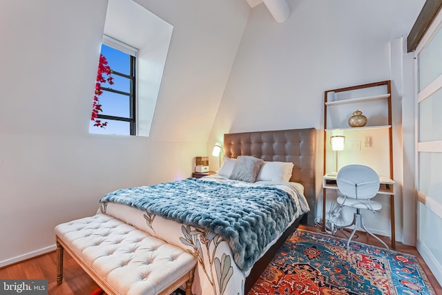 bedroom with baseboards and wood finished floors