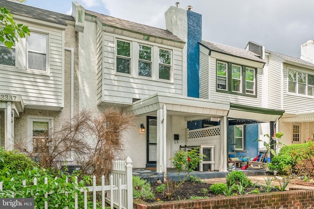 multi unit property with fence and covered porch
