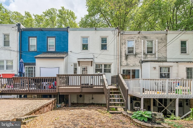 back of house featuring a wooden deck