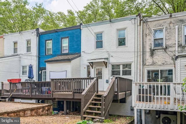 back of property featuring a wooden deck