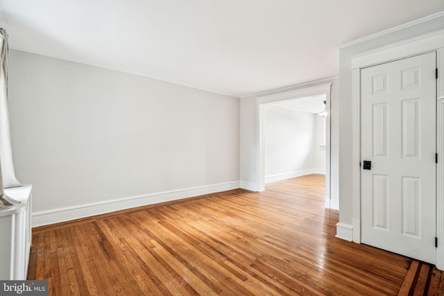 spare room featuring light wood finished floors and baseboards