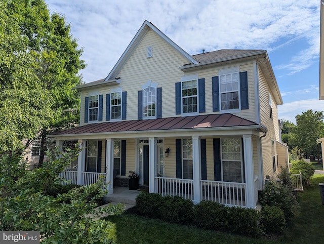 view of front of house with covered porch, a standing seam roof, and metal roof