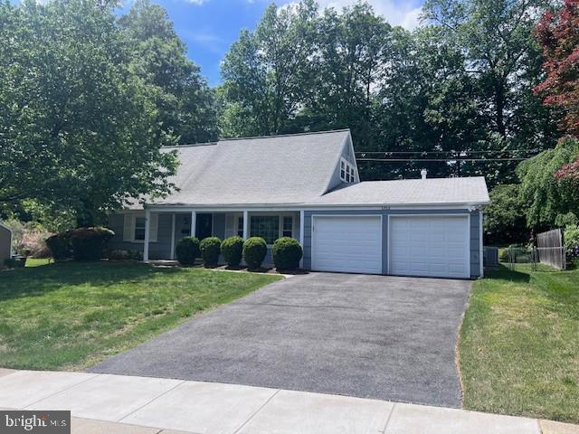view of front of house featuring a garage, driveway, and a front yard