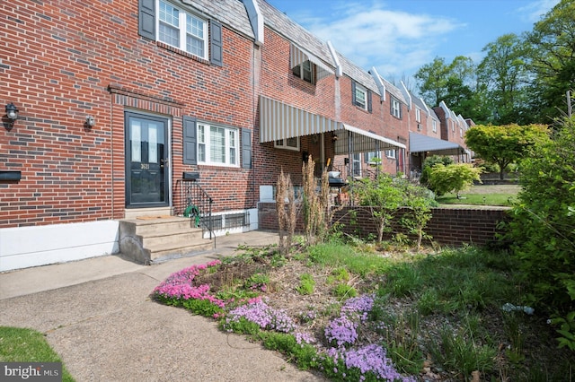 exterior space featuring brick siding