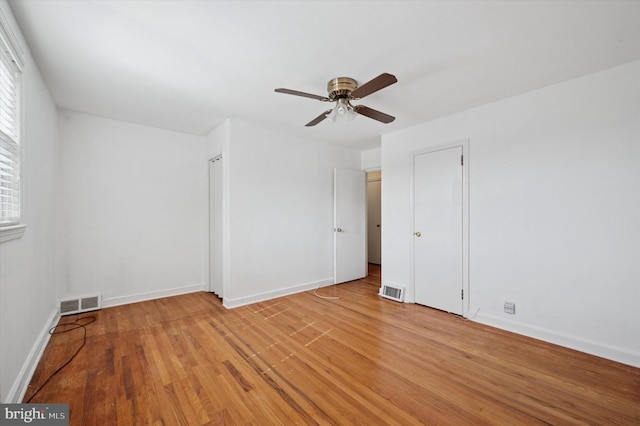 unfurnished bedroom featuring visible vents, light wood finished floors, and baseboards