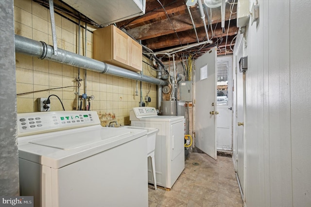 laundry area featuring cabinet space, electric panel, and washing machine and clothes dryer