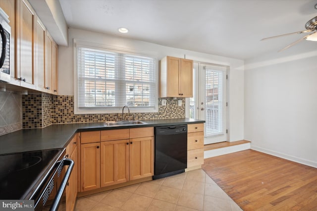 kitchen featuring dark countertops, ceiling fan, a sink, tasteful backsplash, and black appliances