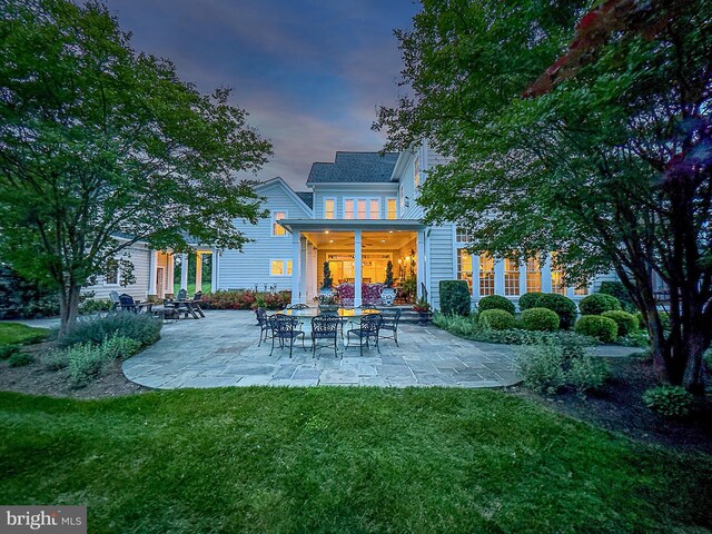 19326 Airwell Ct, Purcellville, VA 20132 - back of house at dusk featuring a lawn and a patio area