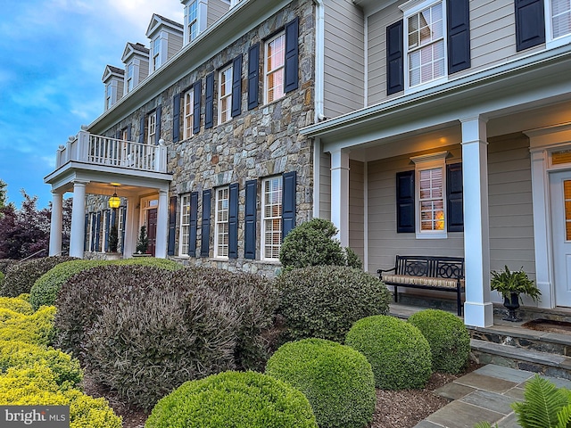 19326 Airwell Ct, Purcellville, VA 20132 - view of side of property featuring covered porch, a balcony, and stone siding
