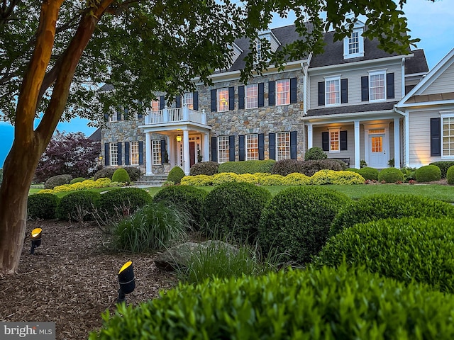 19326 Airwell Ct, Purcellville, VA 20132 - colonial-style house with stone siding and a balcony