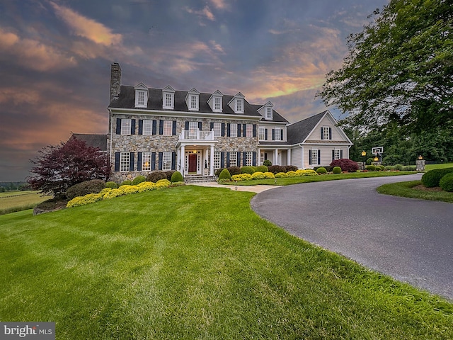 19326 Airwell Ct, Purcellville, VA 20132 - colonial-style house featuring a chimney, a front lawn, and stone siding