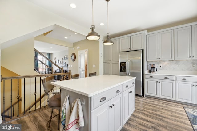10723 Caledonia Meadow Dr, Manassas, VA 20112 - kitchen with stainless steel refrigerator with ice dispenser, wood finished floors, light countertops, recessed lighting, and tasteful backsplash