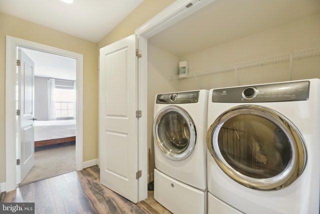 10723 Caledonia Meadow Dr, Manassas, VA 20112 - laundry area with washer and dryer, wood finished floors, and baseboards