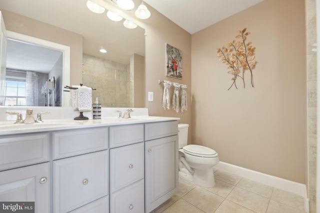 10723 Caledonia Meadow Dr, Manassas, VA 20112 - bathroom featuring toilet, tile patterned flooring, double vanity, a tile shower, and baseboards