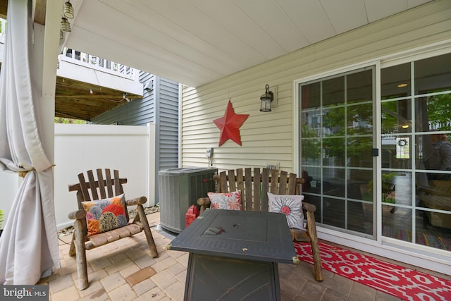 10723 Caledonia Meadow Dr, Manassas, VA 20112 - view of patio / terrace with central AC unit and fence