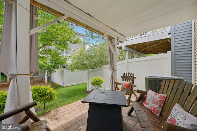 10723 Caledonia Meadow Dr, Manassas, VA 20112 - view of patio / terrace with fence, a fire pit, and central AC unit