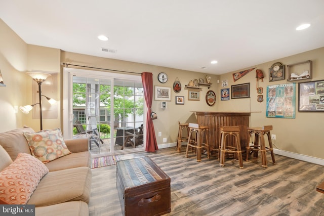 10723 Caledonia Meadow Dr, Manassas, VA 20112 - living area with a bar, wood finished floors, baseboards, and recessed lighting