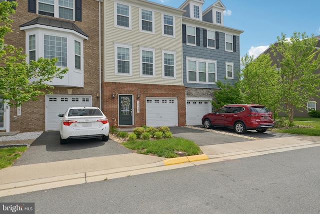 10723 Caledonia Meadow Dr, Manassas, VA 20112 - multi unit property featuring driveway, a garage, and brick siding