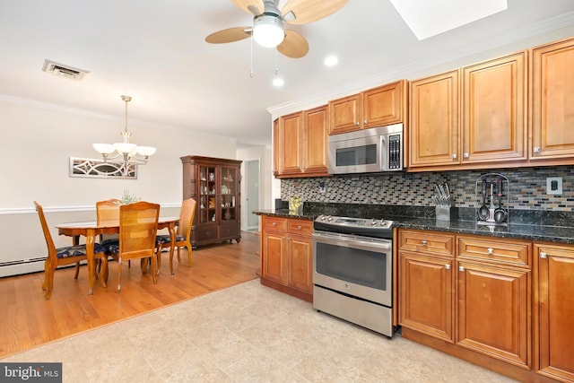 kitchen featuring crown molding, stainless steel appliances, and backsplash