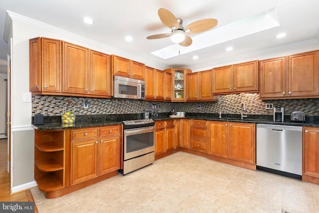 kitchen with open shelves, stainless steel appliances, brown cabinetry, ceiling fan, and tasteful backsplash