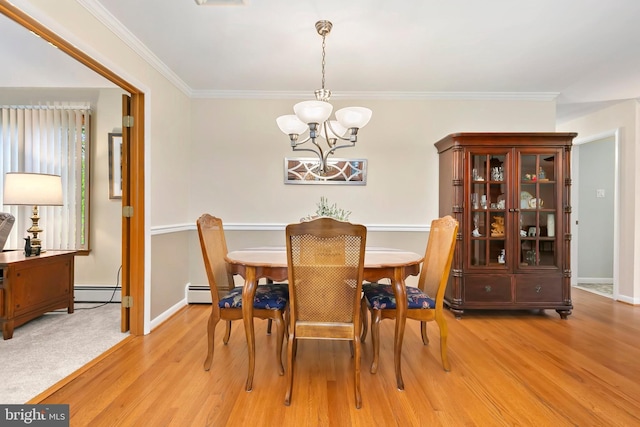 dining space featuring an inviting chandelier, light wood-type flooring, baseboards, and a baseboard heating unit