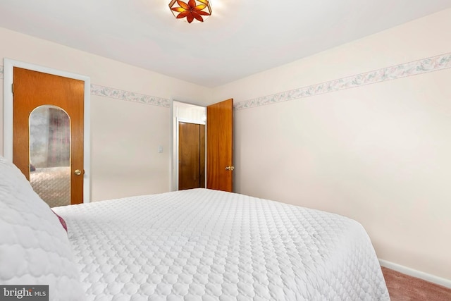 carpeted bedroom featuring baseboards