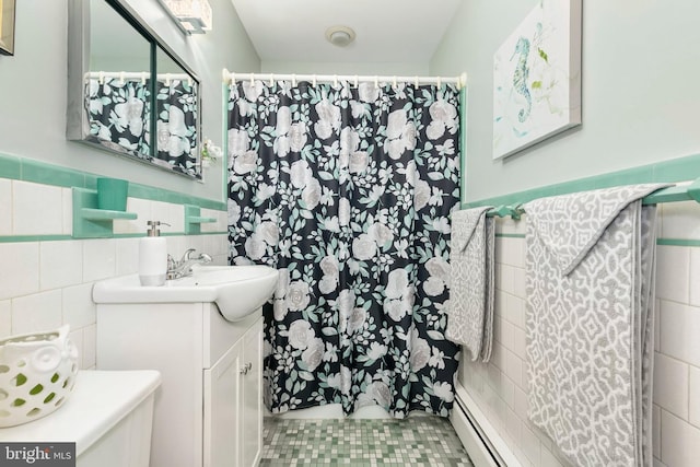 bathroom with a wainscoted wall, tile patterned floors, tile walls, curtained shower, and vanity