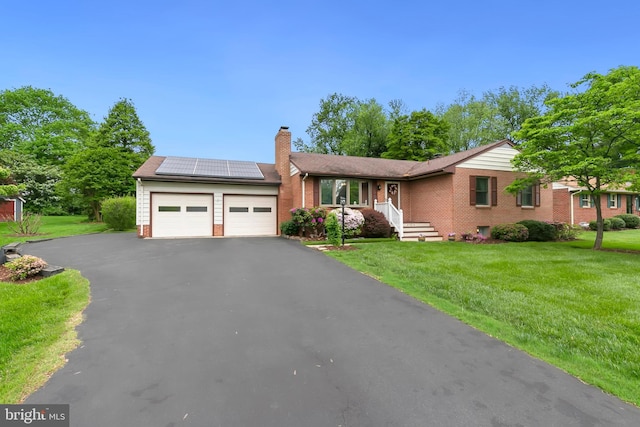 ranch-style house featuring aphalt driveway, an attached garage, a chimney, and brick siding