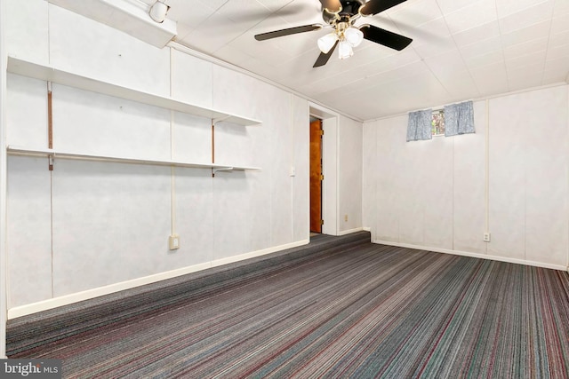 interior space featuring dark colored carpet and ceiling fan