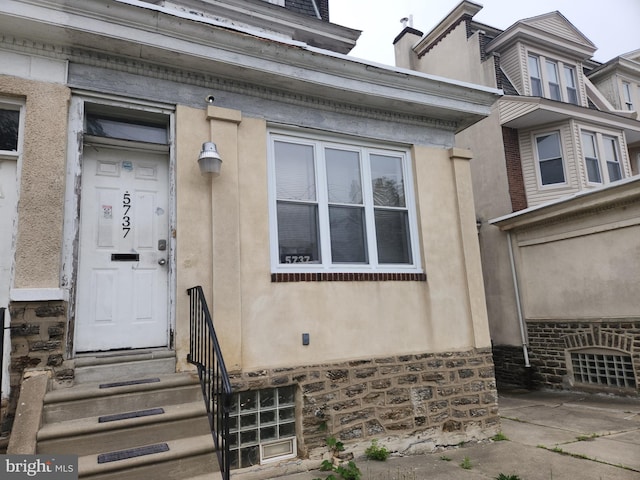 5737 N Park Ave, Philadelphia, PA 19141 - property entrance with a chimney, stone siding, and stucco siding