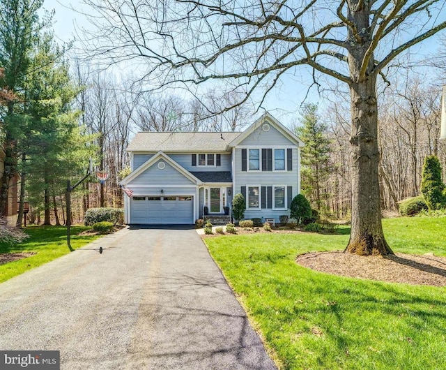 6724 Passageway Pl, Burke, VA 22015 - traditional-style house featuring driveway, a garage, and a front lawn