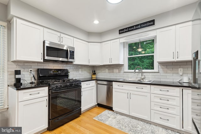 6724 Passageway Pl, Burke, VA 22015 - kitchen with appliances with stainless steel finishes, a sink, white cabinetry, dark countertops, and recessed lighting