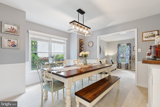 6724 Passageway Pl, Burke, VA 22015 - dining area with light colored carpet, healthy amount of natural light, a chandelier, and baseboards