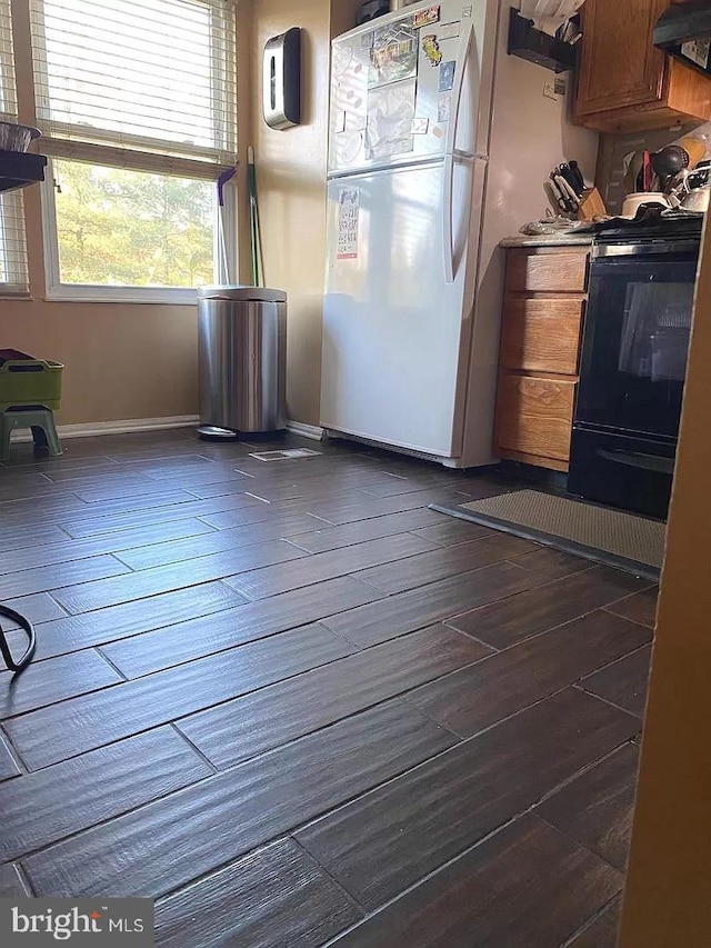 interior space with dark wood-type flooring and baseboards