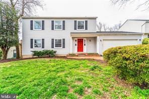 view of front of home with a front lawn and a garage