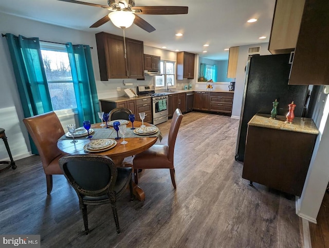 dining space featuring a ceiling fan, plenty of natural light, and wood finished floors