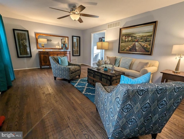 living room featuring baseboards, visible vents, wood finished floors, and a ceiling fan