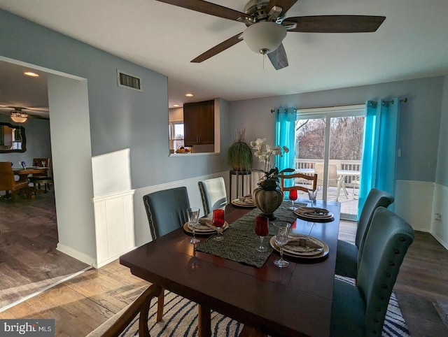 dining area featuring ceiling fan, visible vents, and wood finished floors