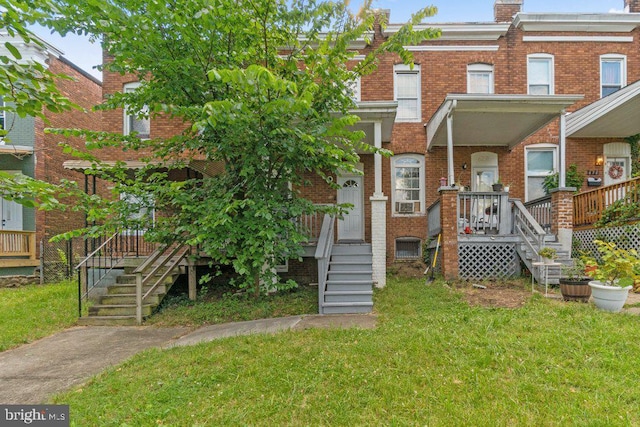 626 Denison St, Baltimore, MD 21229 - view of front of home with brick siding, stairway, and a front yard